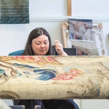 Kim Tourret, who graduated from the Centre for Textile Conservation at University of Glasgow in 2018, spent her first year out of school participating in a one-year internship jointly funded by The Clothworkers’ Company and developing tapestry conservation skills at Historic Royal Palaces. © Historic Royal Palaces. 